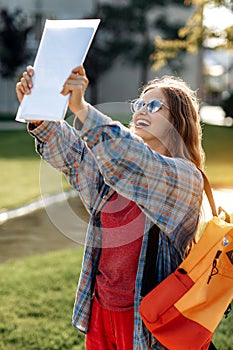 Close-up image of young blonde woman student celebrate success after exams in university.