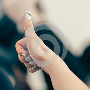 Close up. image of a young businesswoman showing a thumbs up.