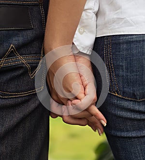 Close-up image of a young couple holding hands