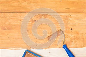 Close-up, impregnation of the wooden floor with a dark varnish roller, manually, there is a place for inscription