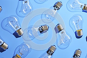 Close-up of an incandescent lamp on blue background.