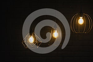 Close-up of an incandescent lamp. Light bulb with orange light. Burning an incandescent edison lamp with a large decorative spiral