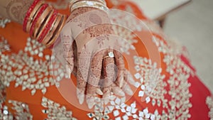 Close-up of Indian bride's hands covered with mehndi. Indian wedding ceremony.