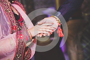 Close up of Indian couple`s hands at a wedding