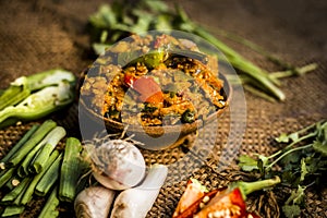 Close up of Indian Dish eaten in winter season Baingan ka Bharta with vegetables like:Spring onions,Allium fistulosum,Coriander,Co