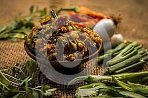 Close up of Indian Dish eaten in winter season Baingan ka Bharta with vegetables like:Spring onions,Allium fistulosum,Coriander,Co