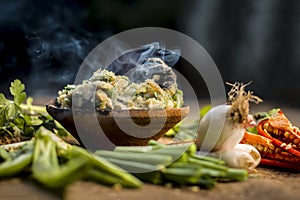 Close up of Indian Dish eaten in winter season Baingan ka Bharta with vegetables like:Spring onions,Allium fistulosum,Coriander,Co