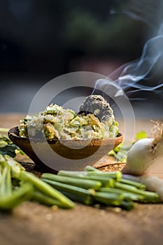 Close up of Indian Dish eaten in winter season Baingan ka Bharta with vegetables like:Spring onions,Allium fistulosum,Coriander,Co