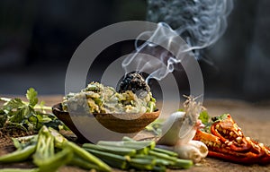 Close up of Indian Dish eaten in winter season Baingan ka Bharta with vegetables like:Spring onions,Allium fistulosum,Coriander,Co