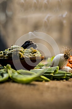 Close up of Indian Dish eaten in winter season Baingan ka Bharta with vegetables like:Spring onions,Allium fistulosum,Coriander,Co