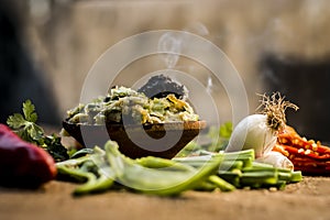 Close up of Indian Dish eaten in winter season Baingan ka Bharta with vegetables like:Spring onions,Allium fistulosum,Coriander,Co