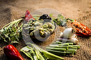 Close up of Indian Dish eaten in winter season Baingan ka Bharta with vegetables like:Spring onions,Allium fistulosum,Coriander,Co