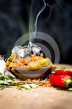 Close up of Indian Dish eaten in winter season Baingan ka Bharta with vegetables like:Spring onions,Allium fistulosum,Coriander,Co