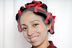 Close-up of Indian girl with curlers in her hairs.