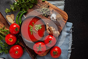 Close-up of Indian Homemade fresh and healthy tomato soup garnished with fresh coriander leaves and ingredients and herbs, served