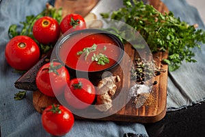 Close-up of Indian Homemade fresh and healthy tomato soup garnished with fresh coriander leaves and ingredients and herbs, served