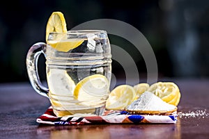 Close up of Indian most popular summer drink Nimbu pani or Nimbo sarbat,Lemonade in a transparent glass with salt photo