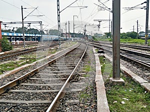 Close Up of Indian Railway Tracks low angel view from a rails sleepers near railway station platform during day time in Howrah