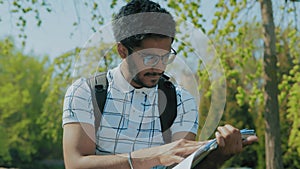Close-Up,Indian Student with Glasses Reading medical Literature in the Park