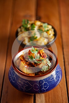 Close-up of Indian vegetarian classic combination of dishes  Jeera Aloo Potatoes in cumin Flavored  and spicy Potato and Tomato