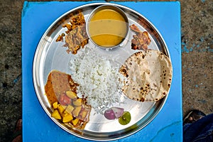 Close-up of Indian Vegetarian Thali with various dishes served in stainless steel bowl and plate