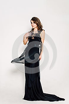 Close up. Individuality. Thoughtful Elegant Lady in Black Prom Evening Dress. Studio retouched photo.