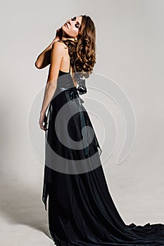 Close up. Individuality. Thoughtful Elegant Lady in Black Prom Evening Dress. Studio retouched photo.