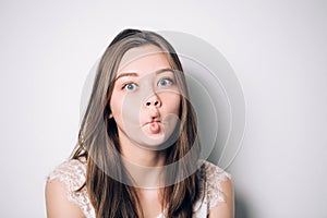 Close up indoor fashion lifestyle portrait of pretty young brunette girl, long hairs, cute face, making crazy funny grimace. funny