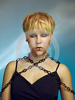 Close-up indoor portrait of lovely girl with blonde hair. Studio shot of graceful young woman with short haircut