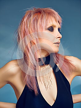 Close-up indoor portrait of lovely girl with blonde hair. Studio shot of graceful young woman with short haircut