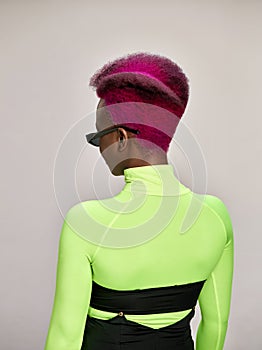 Close-up indoor portrait of lovely girl with colorful hair. Studio shot of graceful young woman with long haircut