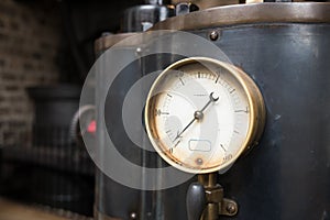 Close up of an industrial pressure gauge.