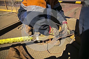 Rope access worker commencing safety final checking inspecting of black rope protection photo