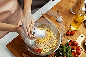 Close up influencer cooking spaghetti mix ingredient to frying pan. Postulate.