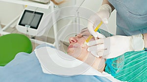 Close-up of injecting plasma under a client's skin for rejuvenation.