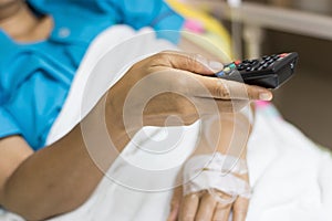 Inpatient woman`s Hand are using remote control for