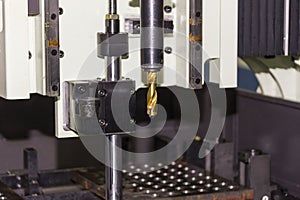 Close up insert carbide at end of drill bit at automatic drilling machine at workshop
