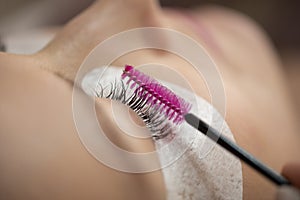 Close-up of the insertion of artificial eyelashes