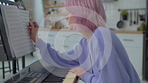 Close-up of inspired woman musician in creative process of composing music