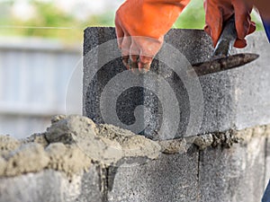 Close up of installing bricks in construction site by industrial bricklayer