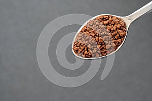 Close up of Instant Coffee on Stainless Steel Tea Spoon, Black Background, Copy Space for Text