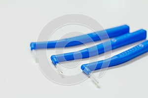 Close-up interdental brushes on white blurred background