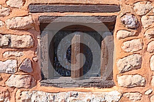 Close up of an interesting old window in a stone wall in the village of Nether Stowey in Somerset, United Kingdom photo