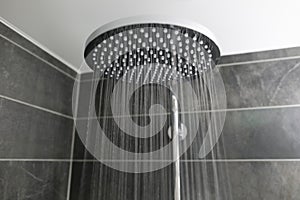 Close-up interior stylish shower spraying water