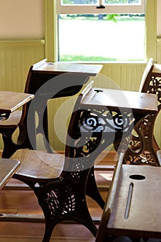 Close up interior view old 19th Century student desks in a schoolhouse