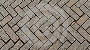 Close-up of interlocking brick pattern arrangement on pavement surface