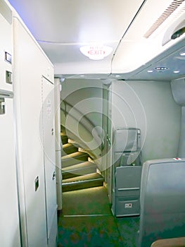 Close-up internal stair way on a double deck airplane, the staircase connects to second floor of super jumbo aircraft cabin