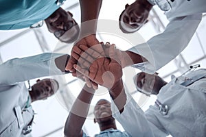 close up. international group of doctors putting their hands together