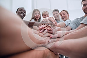 Close up. international group of young people putting their hands together