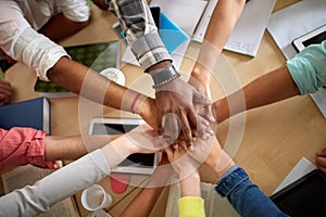 Close up of international students hands on top